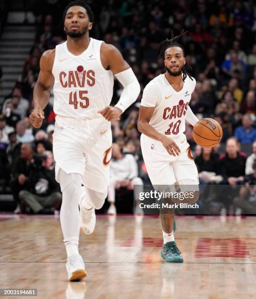 Darius Garland and Donovan Mitchell of the Cleveland Cavaliers bring up the ball against the Toronto Raptors during the first half of their...