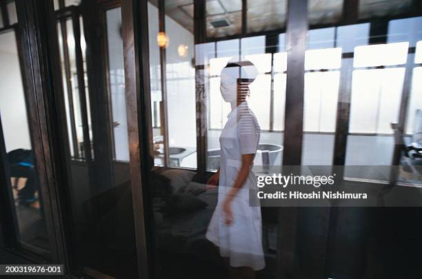 nurse reflection on glass door - bad bangs imagens e fotografias de stock