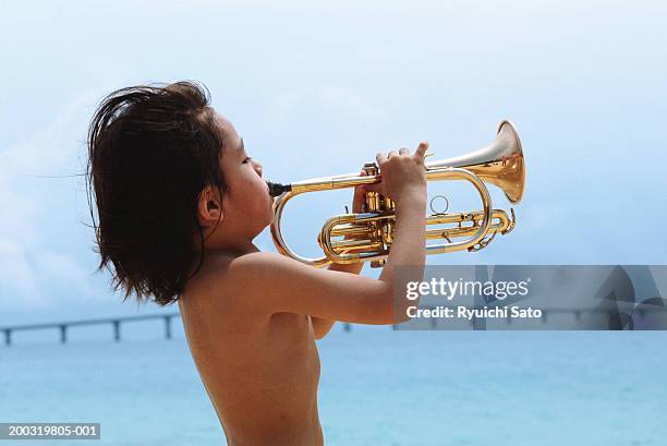 boy (4-5) blowing trumpet, side view - trumpet bildbanksfoton och bilder
