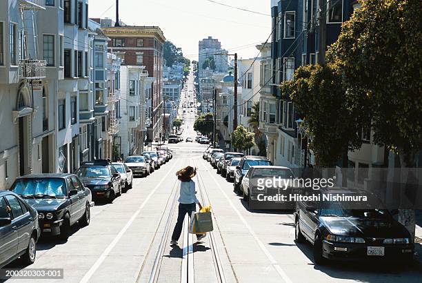 woman walking on road, rear view - san francisco california stock pictures, royalty-free photos & images