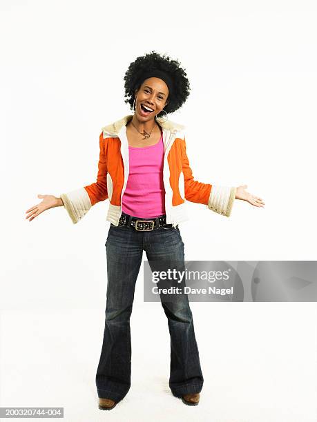 young woman with hands extended outward smiling, portrait - vestido preto imagens e fotografias de stock