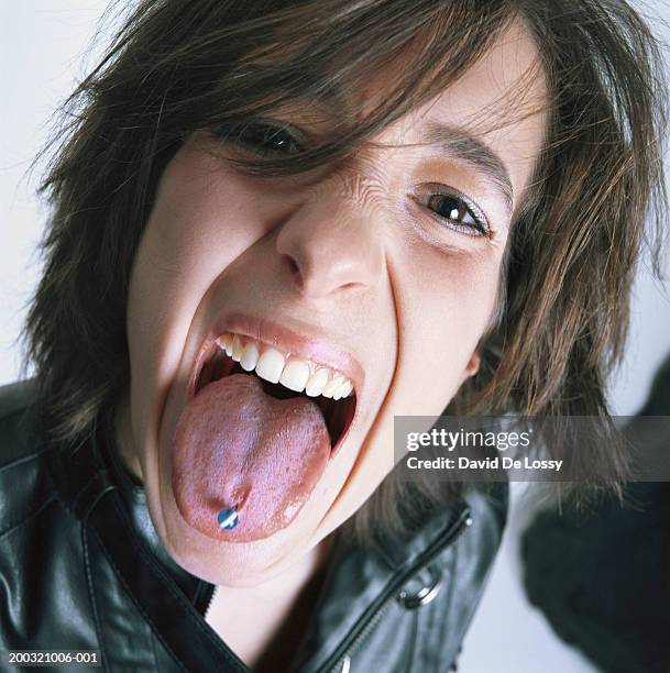 woman sticking out tongue, portrait - tongue stud stock pictures, royalty-free photos & images