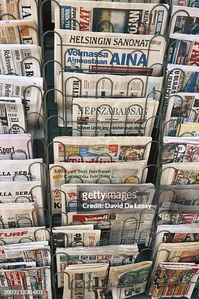 stack of newspapers in rack, elevated view - tidningsstånd bildbanksfoton och bilder