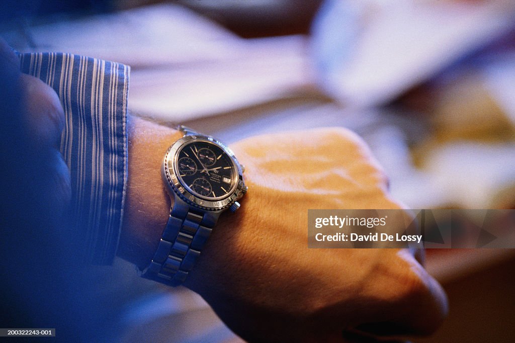 Man checking time on wrist watch, close-up