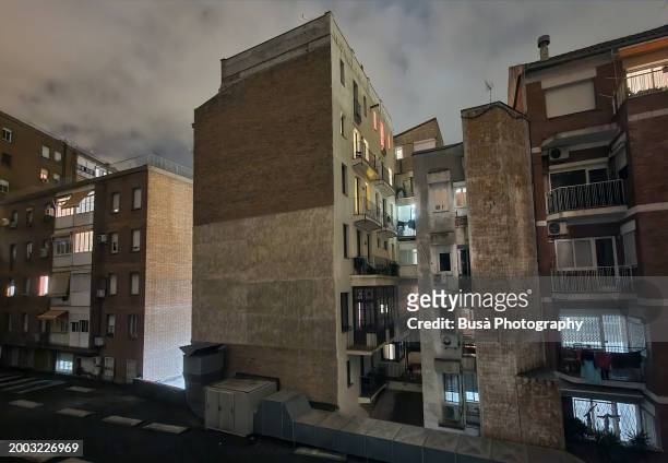 housing buildings with lit windows at night in barcelona, spain - boom for real stock pictures, royalty-free photos & images