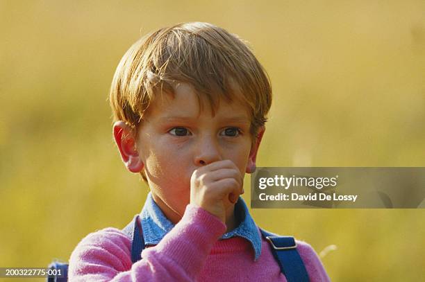 boy (4-5) with thumb in mouth, looking away - thumb sucking stock pictures, royalty-free photos & images
