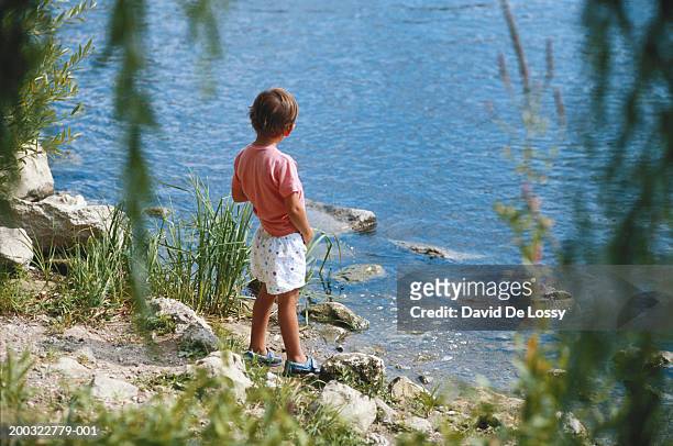 boy (4-5) urinating by river, rear view - kids peeing - fotografias e filmes do acervo