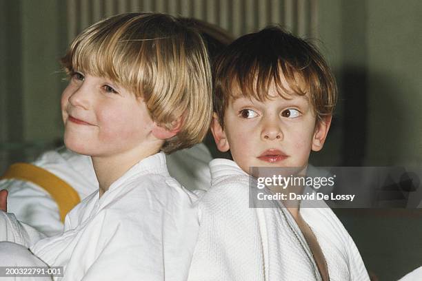 two boys (4-7) wearing karate uniform, looking away, close-up - gidräkt bildbanksfoton och bilder