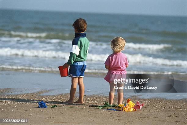 children (3-5) on beach, rear view - flower bucket stock pictures, royalty-free photos & images