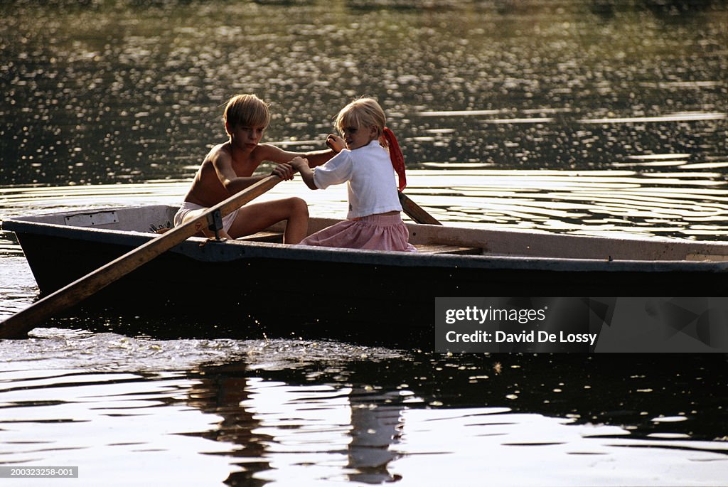 Boy and girl (4-9) canoeing