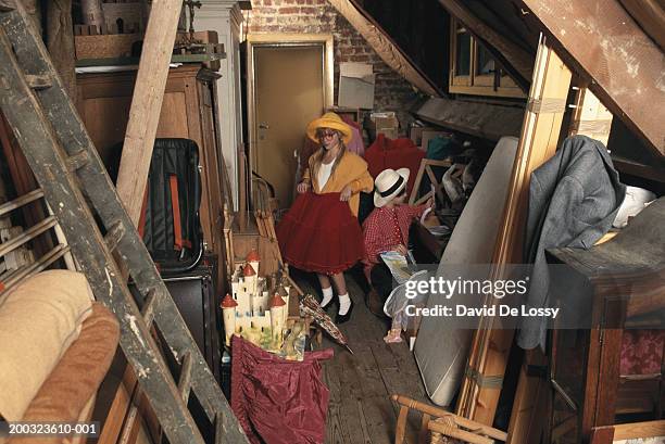 boy and girl (8-13) in storage room - attic storage stock pictures, royalty-free photos & images