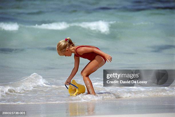 girl-filling-water-in-bucket-