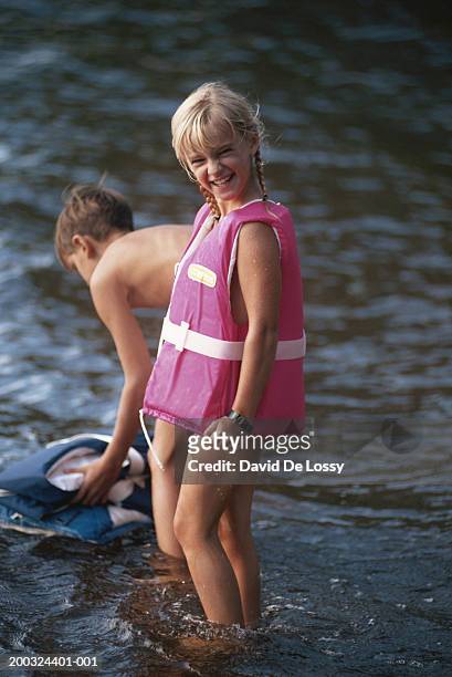 boy and girl (6-9) wearing life jacket in lake - 6 loch stock pictures, royalty-free photos & images