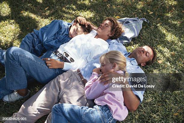 couple sleeping with children (6-9) in garden - david de lossy sleep stock pictures, royalty-free photos & images