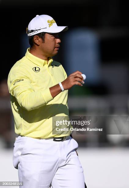 Hideki Matsuyama of Japan waves on the 17th green during the continuation of the third round of the WM Phoenix Open at TPC Scottsdale on February 11,...