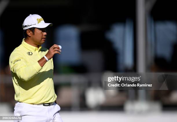 Hideki Matsuyama of Japan waves on the 17th green during the continuation of the third round of the WM Phoenix Open at TPC Scottsdale on February 11,...