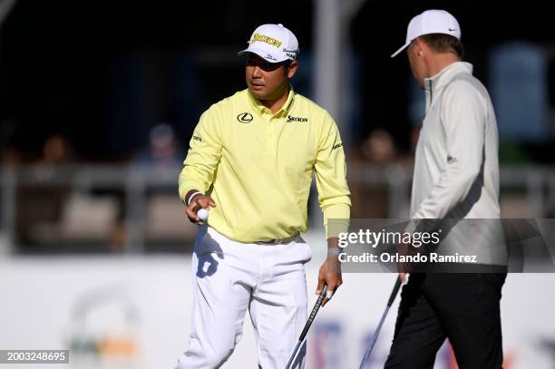 Hideki Matsuyama of Japan waves on the 17th green during the continuation of the third round of the WM Phoenix Open at TPC Scottsdale on February 11,...