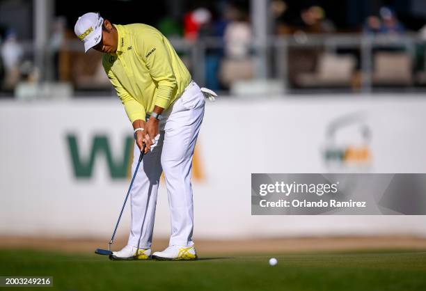 Hideki Matsuyama of Japan putts on the 17th green during the continuation of the third round of the WM Phoenix Open at TPC Scottsdale on February 11,...