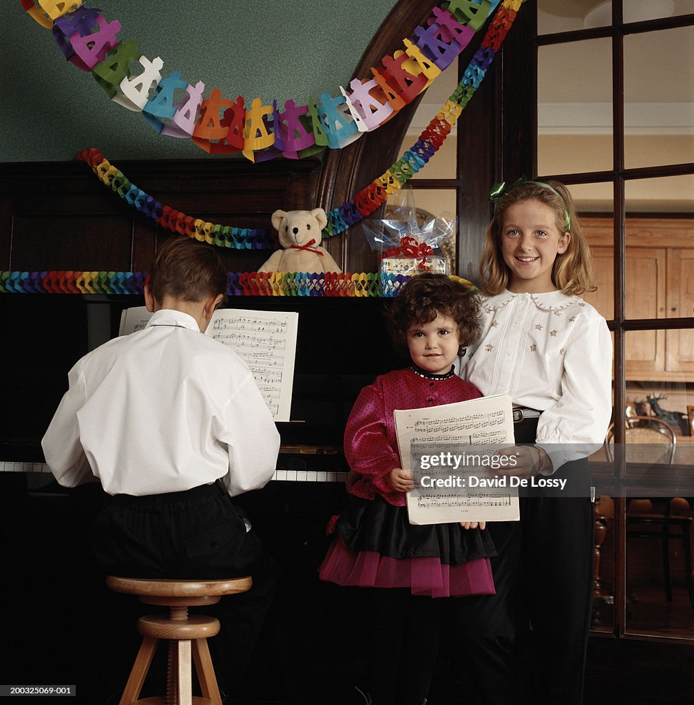 Children (4-11) by piano with musical notes