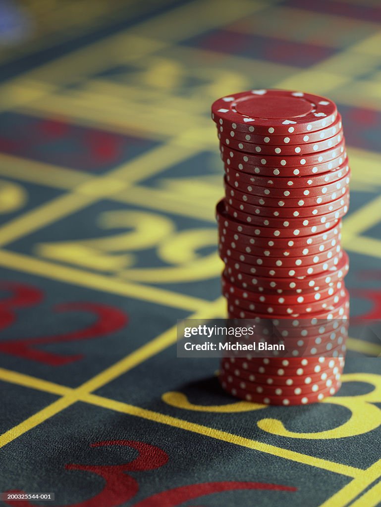 Stack of red gambling chips on roulette table, close-up