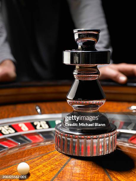 man leaning on roulette table, (focus on wheel) - roulotte stock pictures, royalty-free photos & images