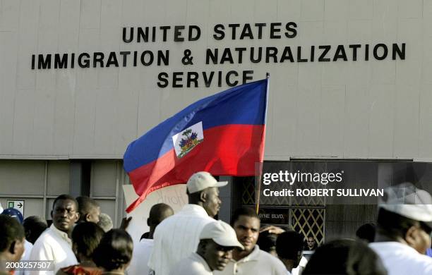 Haitians protest outside the US Immigration and Naturalization Service building 30 October 2002 in Miami, FL. The protesters call for equal treatment...