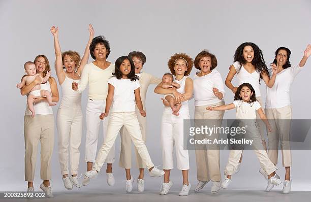group of multi-generational family, jumping, portrait - 40s woman t shirt studio stock pictures, royalty-free photos & images