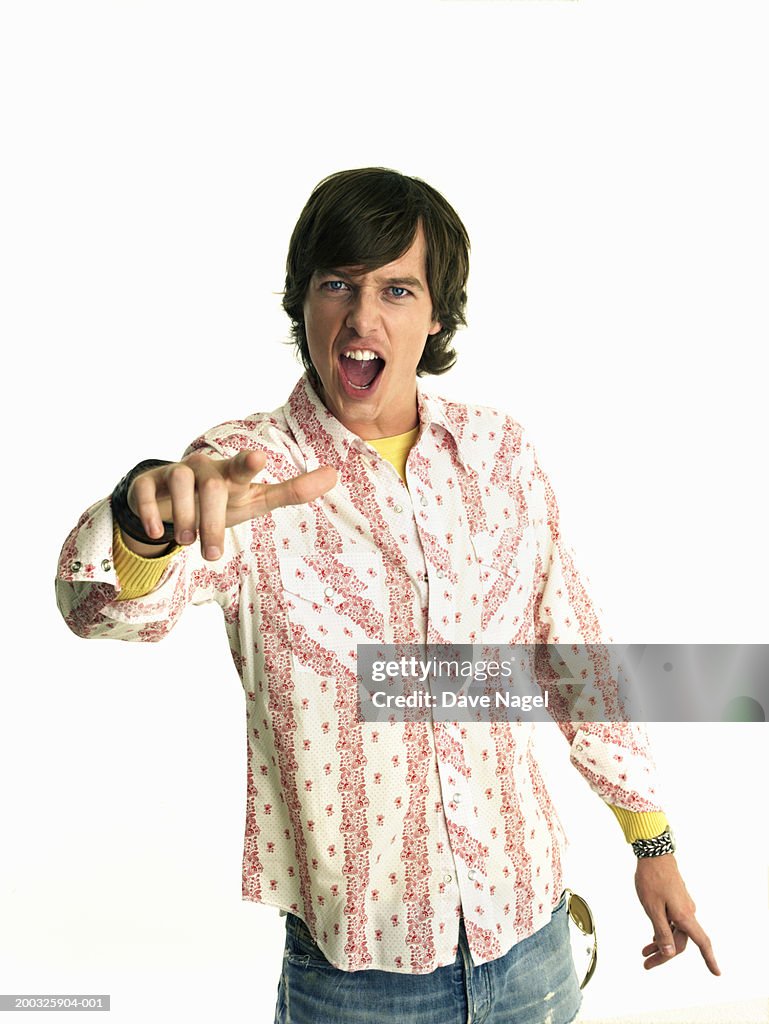 Young man pointing, portrait, close-up