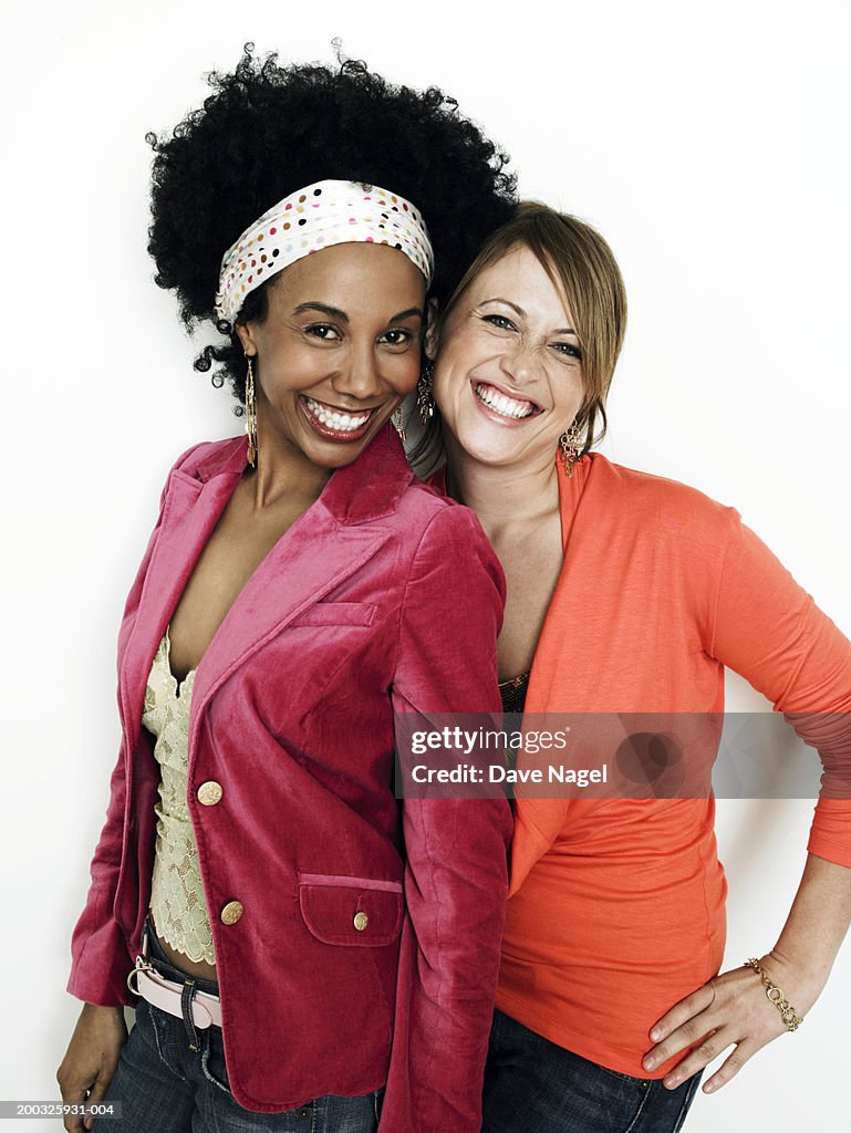 Two young woman smiling, portrait, close-up
