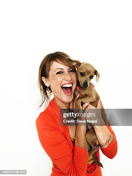 young woman embracing dog, laughing, portrait, close-up - happy dog on white fotografías e imágenes de stock