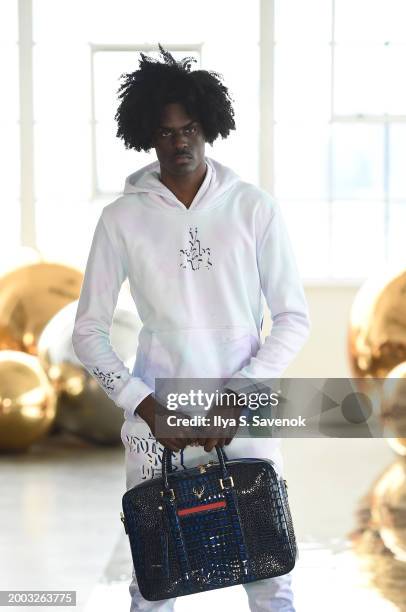 Model walks the runway wearing OS VMC with Suave Suede bags during Flying Solo NYFW February 2024 at Canoe Studios on February 11, 2024 in New York...