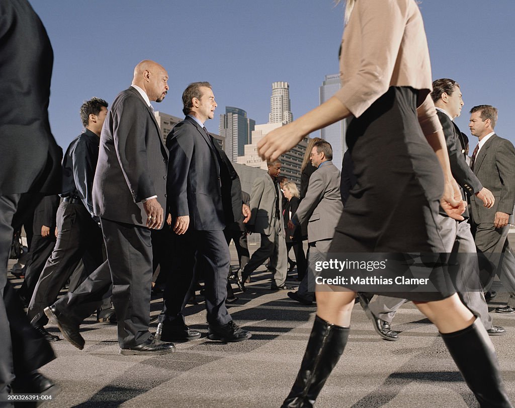 Commuters crossing street, side view