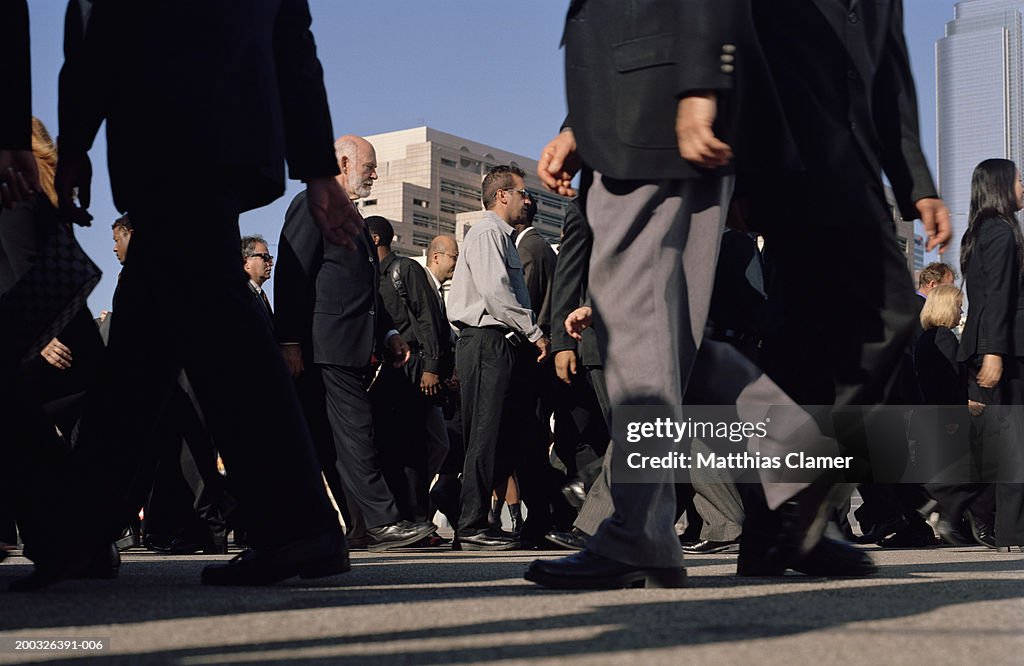 Commuters crossing street, side view, ground view