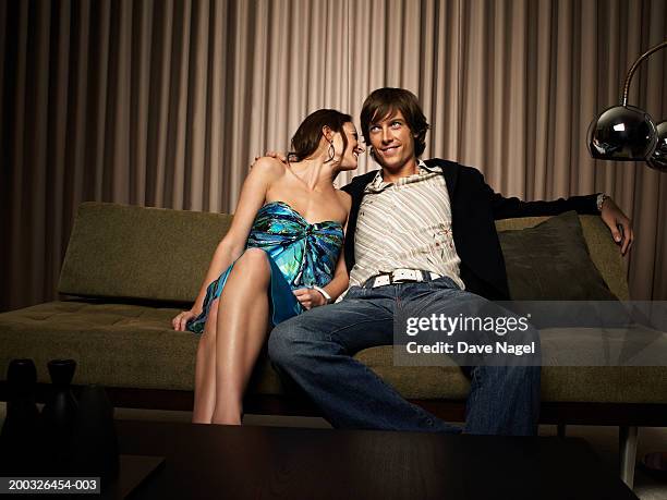 young woman whispering in man's ear - woman whisper to man stock pictures, royalty-free photos & images