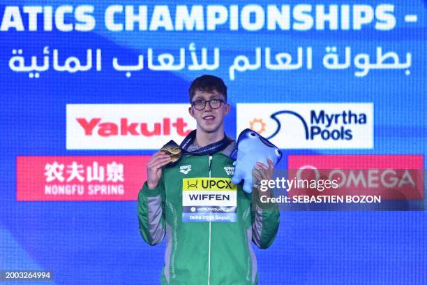 Ireland's Daniel Wiffen poses with his gold medal on the podium of the men's 800m freestyle swimming event during the 2024 World Aquatics...