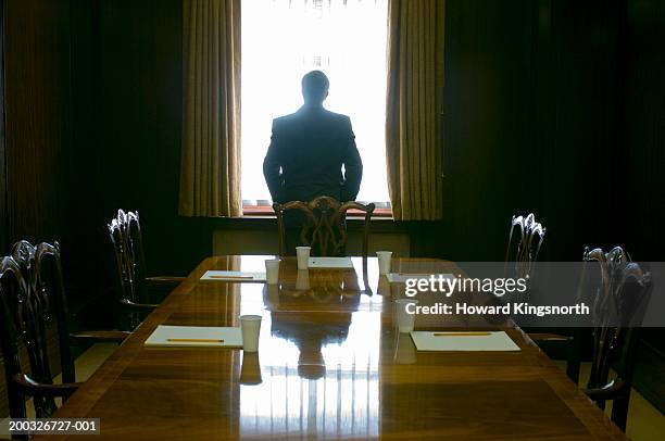 businessman facing window in meeting room, rear view - leadership conference day 1 stock-fotos und bilder