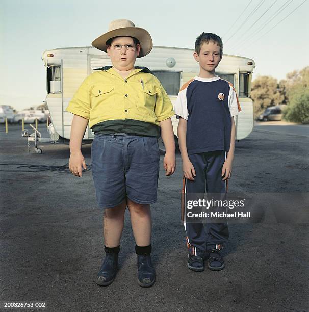 two boys (6-8) standing by caravan, portrait - pojkscout bildbanksfoton och bilder