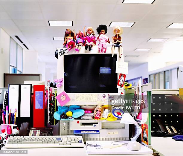 dolls and stickers on computer monitor in office - desk toy 個照片及圖片檔