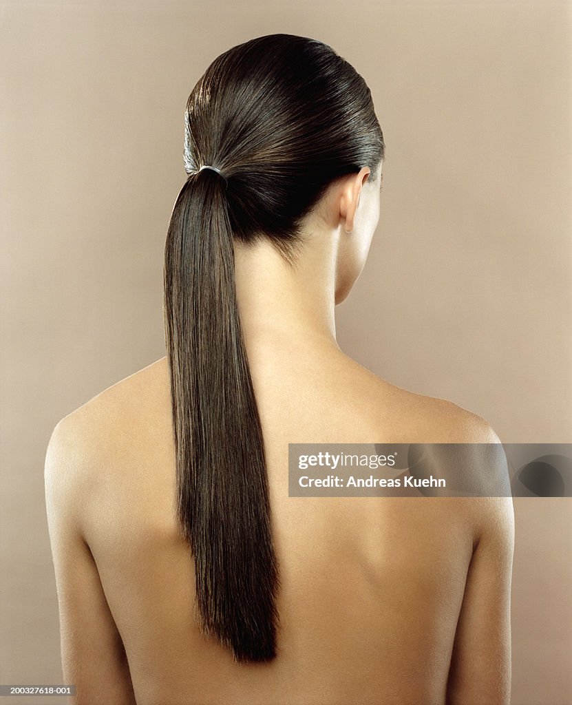 Woman with hair in ponytail, rear view