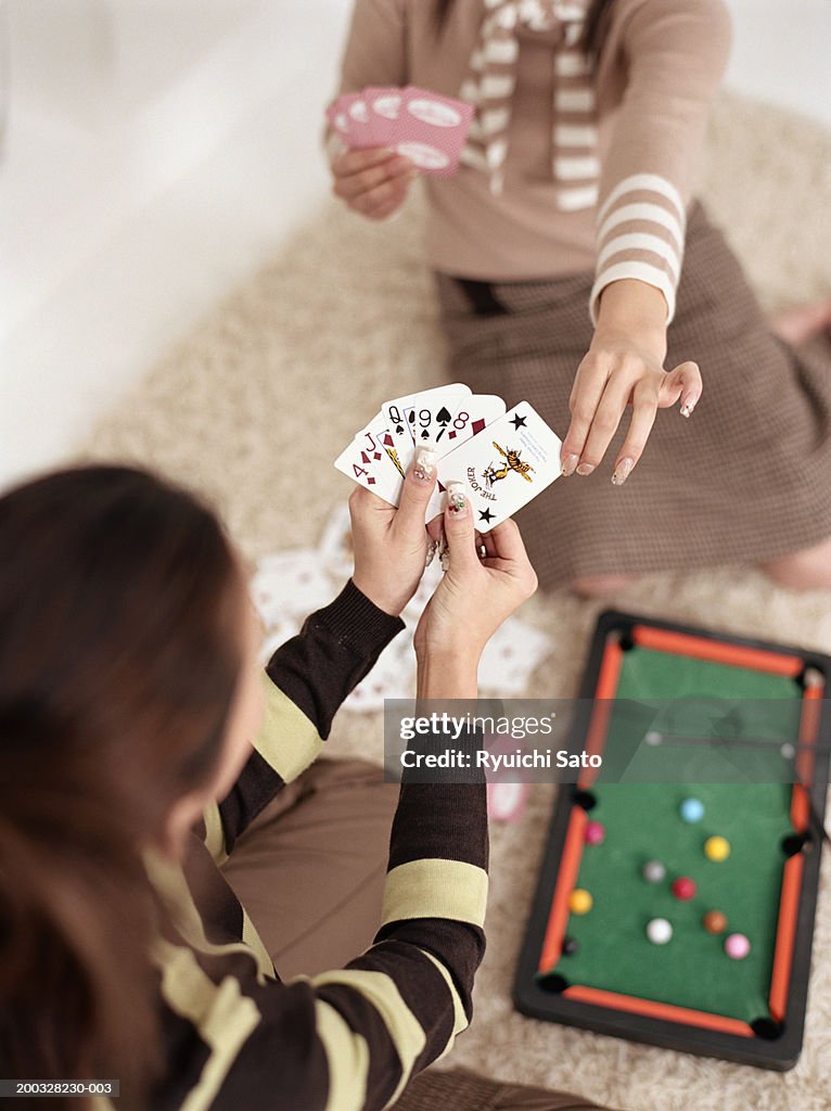 Two women playing cards, elevated view