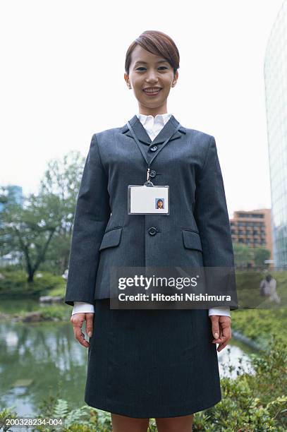 businesswoman wearing identity card smiling, portrait - security pass stock pictures, royalty-free photos & images