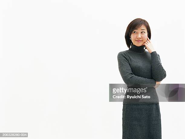 mid adult woman looking to side, smiling - mock turtleneck foto e immagini stock