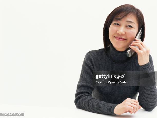 woman using mobile phone, smiling - call to arms stock pictures, royalty-free photos & images