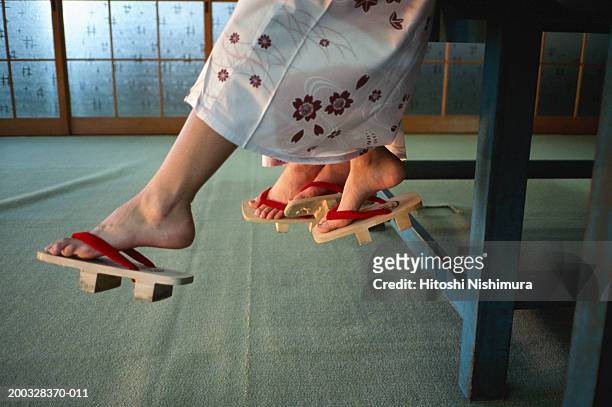 women wearing wooden sandals, low section - geta sandal stock-fotos und bilder