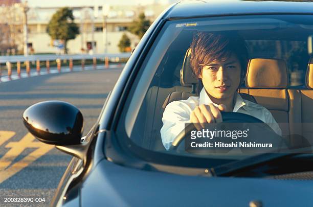young man in car, portrait - handlebar fotografías e imágenes de stock