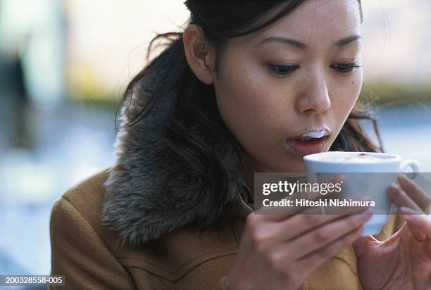young woman drinking cappuccino, close-up - coffee foam imagens e fotografias de stock