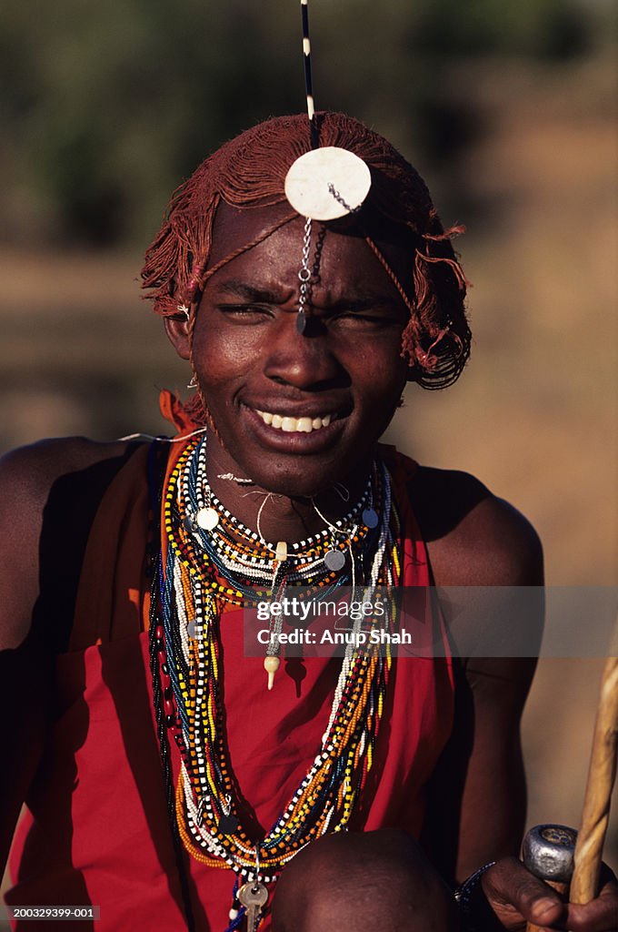 Young Masai posing outdoors, Masai Mara National Reserve, Kenya, portrait