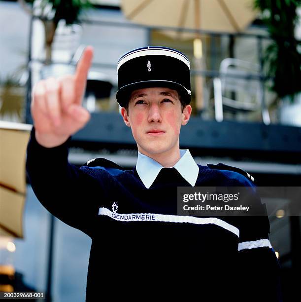 policeman (16-18) pointing, low angle view - french police stock-fotos und bilder