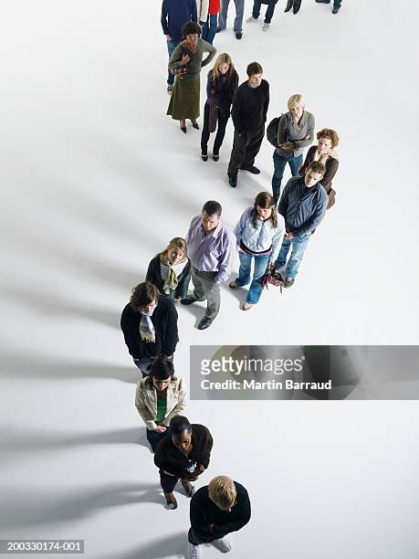 people standing in curved line, elevated view - lining up stock pictures, royalty-free photos & images