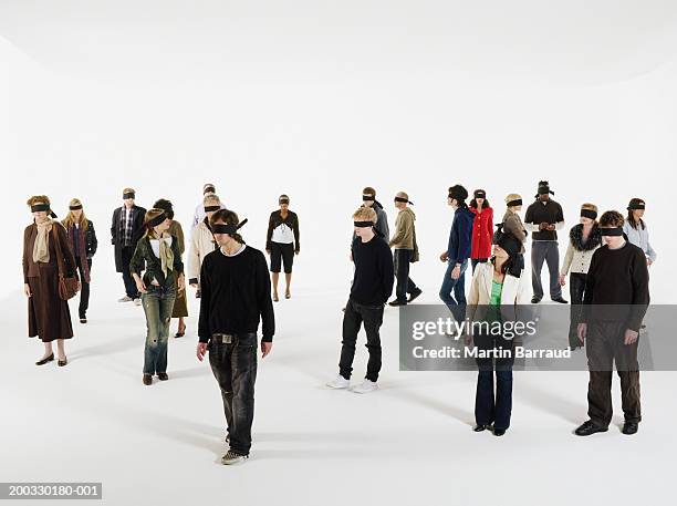 group of people wearing blindfolds - blinddoek stockfoto's en -beelden